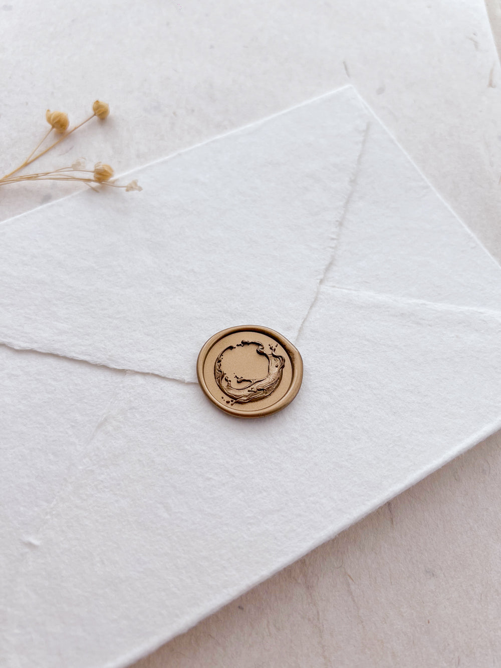 3D ocean waves design gold wax seal on a white envelope 