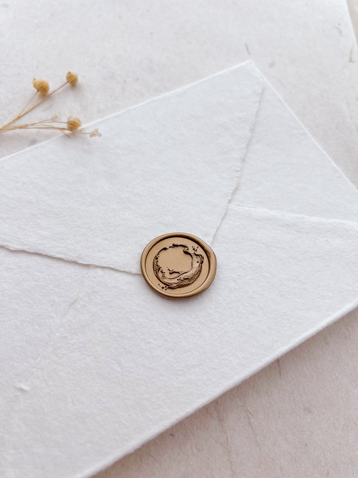 3D ocean waves design gold wax seal on a white envelope 