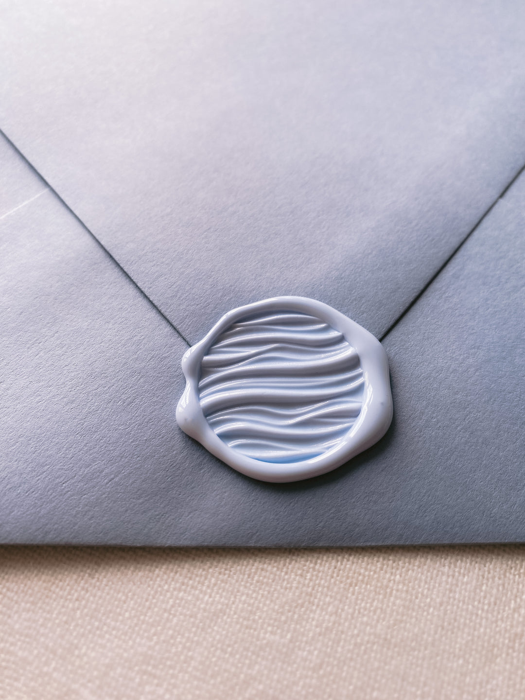 3D waves wax seal in pale blue on blue paper envelope