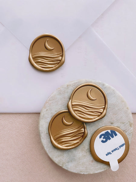 3D moonlight wax seals in gold with 3m sticker on small gray stone dish