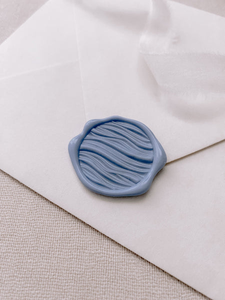 3D waves wax seal in French blue on white paper envelope