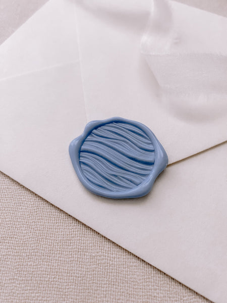 3D ocean waves design wax seal in dusty blue on paper envelope_side angle