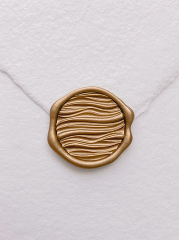 Gold 3D ocean waves wax seal on white handmade paper envelope