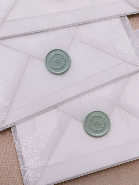 Leaf wreath monogram sage green custom wax seals on vellum envelopes
