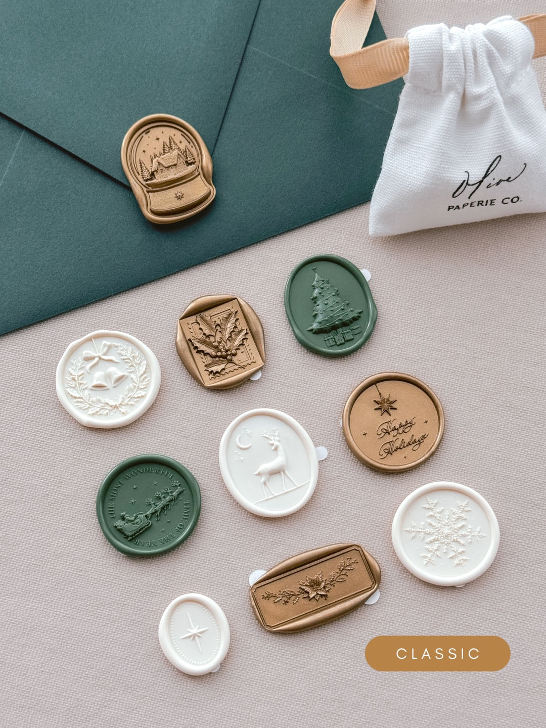 Assorted Christmas wax seal stickers in colors gold, dark green and antique white in various festive motifs including Christmas wreath, holly, Santa sleigh, reindeer, snow globe, North Star, Christmas tree and more.