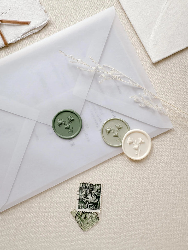 green and white floral wax seal stickers on wedding invitation envelope