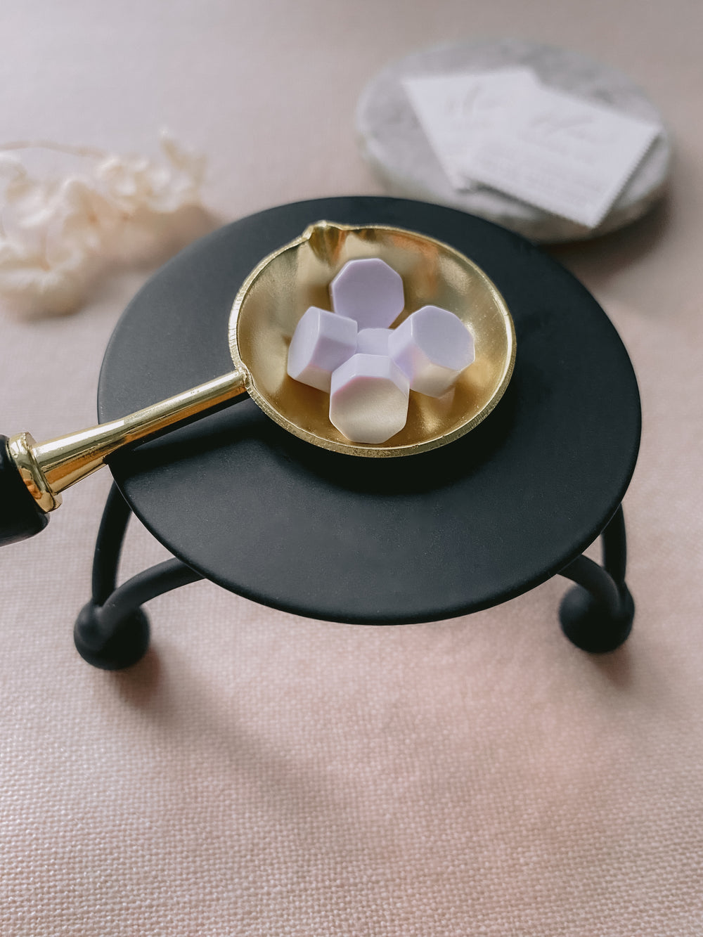 black color melting stove with wax beads in gold color melting spoon