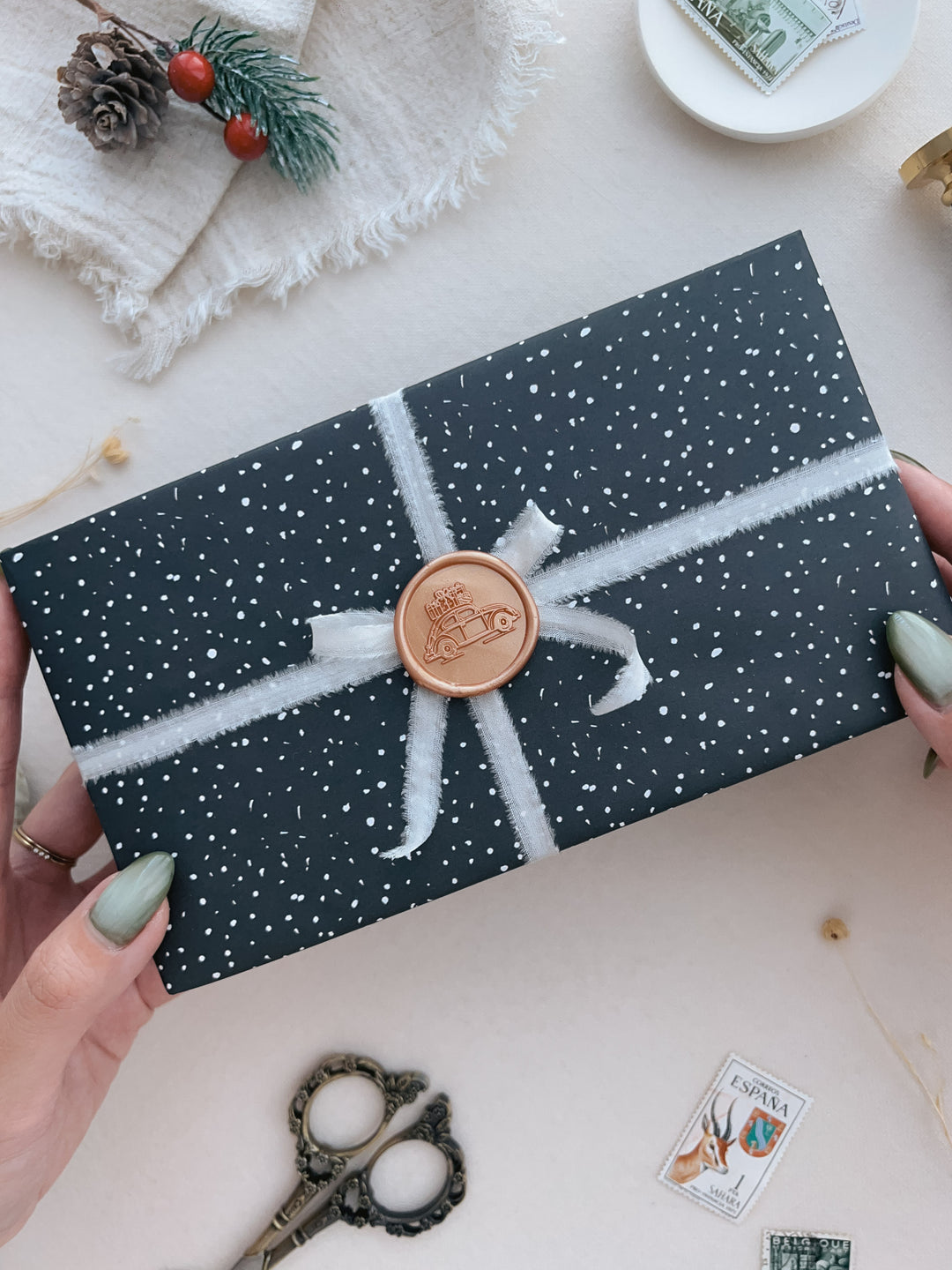 Gift delivery Christmas car wax seal on a wrapped gift