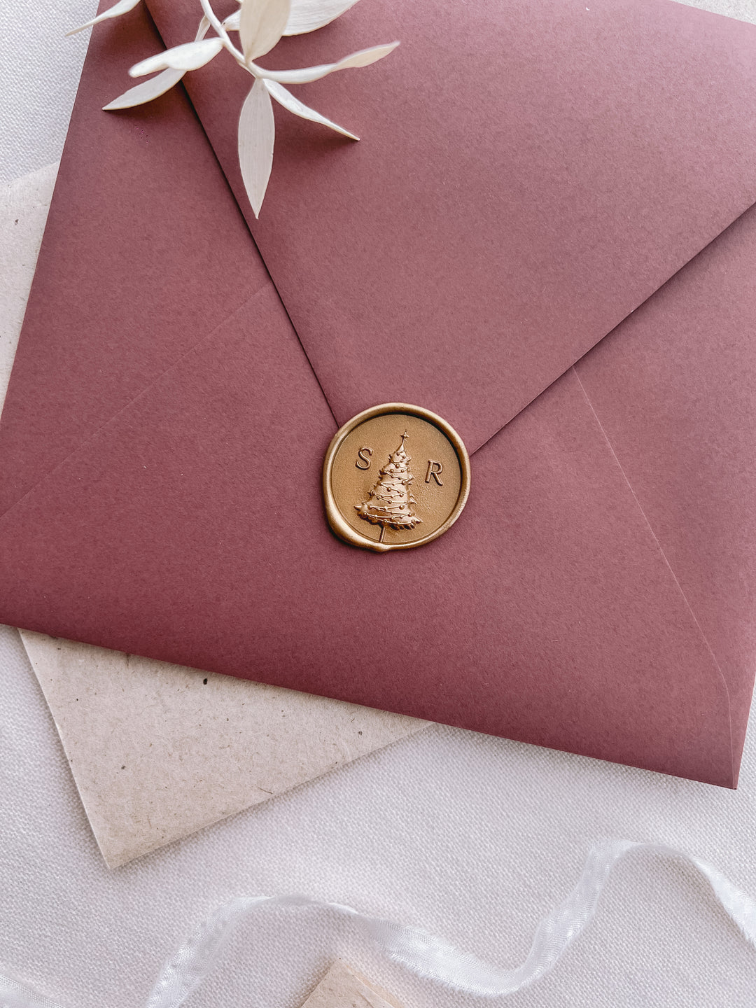 Personalized initials Christmas tree monogram gold wax seal on a red envelope