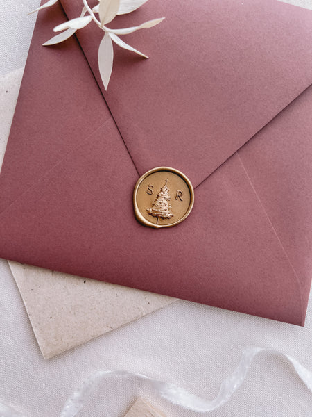 Personalized initials Christmas tree monogram gold wax seal on a red envelope