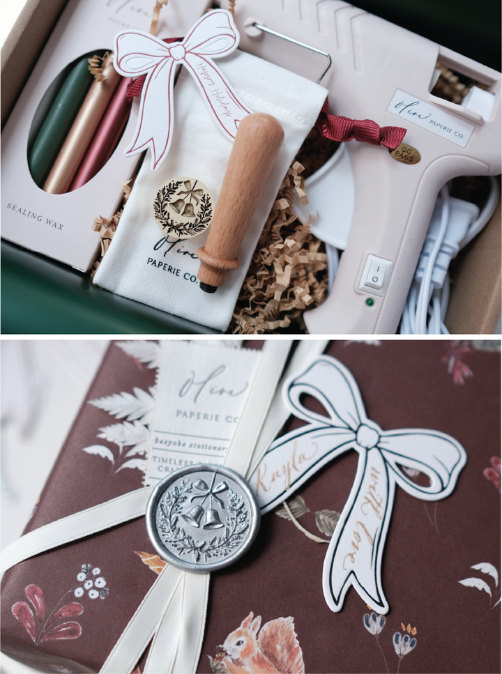 Holiday wax seal kit with a festive Christmas wreath wax stamp, glue gun, wooden handle, sealing wax sticks in assorted festive colors, a silver holiday wreath wax seal on a wrapped Christmas gift