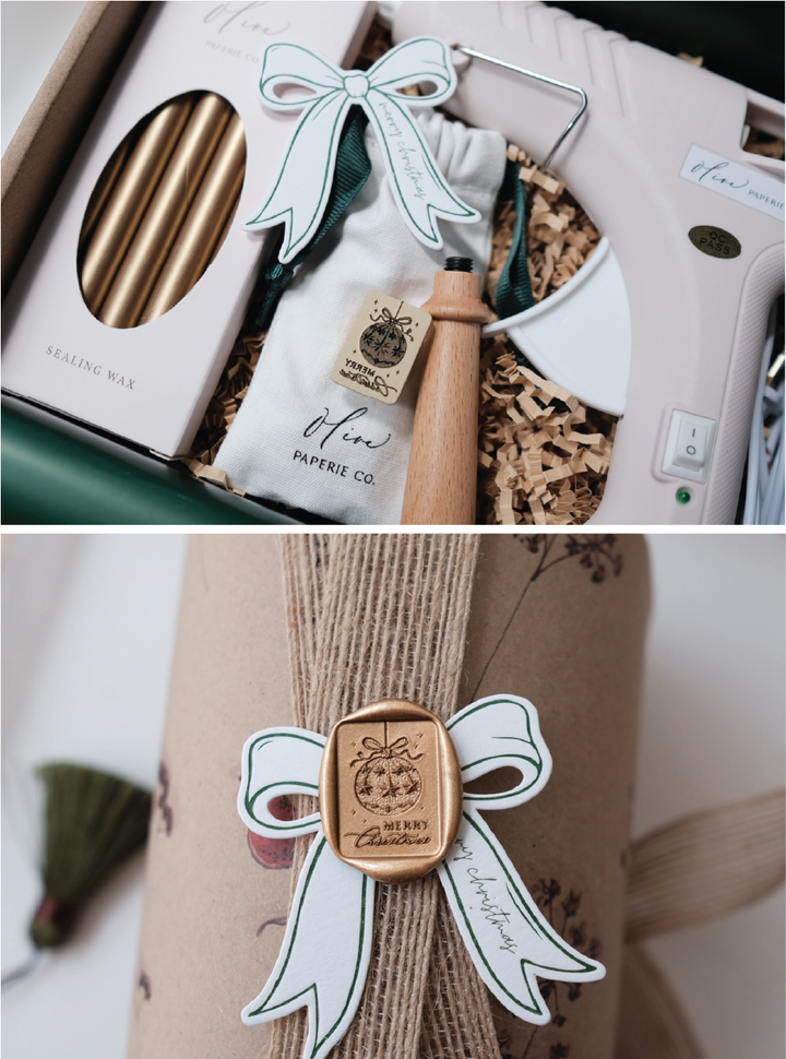 Ornament Merry Christmas wax seal kit with a wax stamp, glue gun, wooden handle, gold sealing wax sticks, a gold Merry Christmas  wax seal on a wrapped Christmas gift