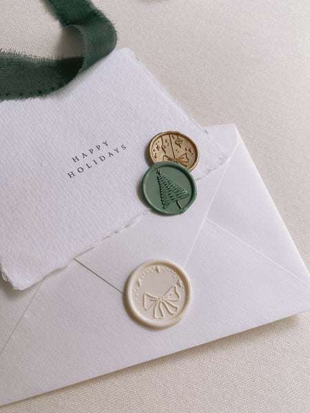 Off-white, green and gold Christmas wax seals with handmade paper Happy Holiday card and envelope
