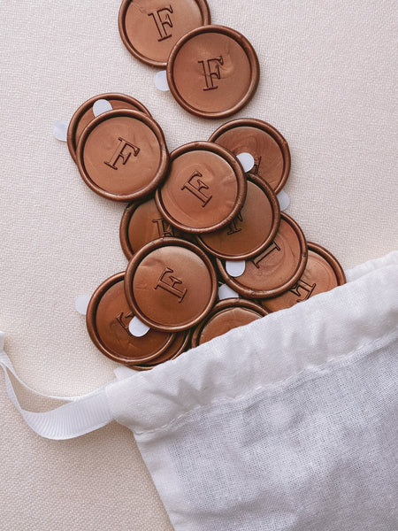 Monogram round custom wax seals in copper in white line bag