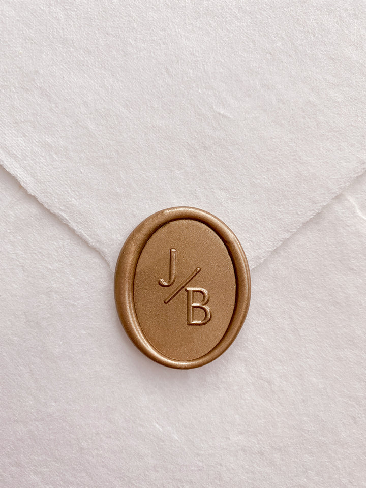 Oval monogram custom wax seal on beige handmade paper envelope