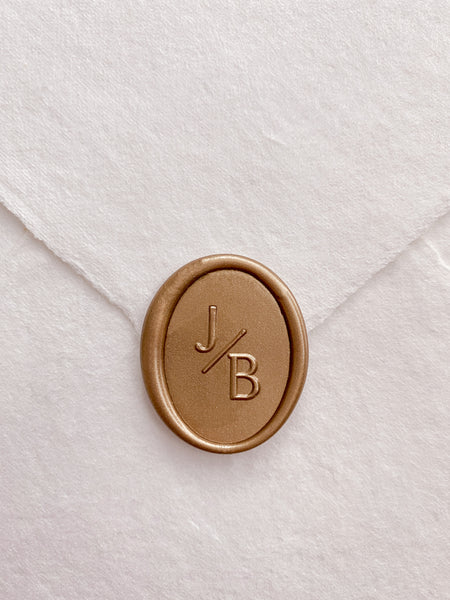 Oval monogram custom wax seal on beige handmade paper envelope