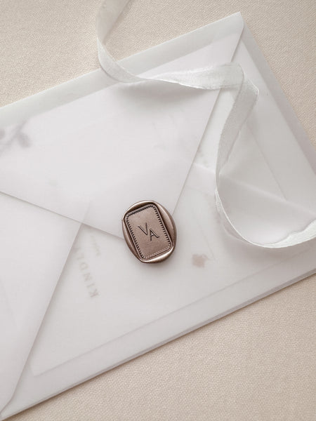 Rectangular border design monogram wax seal in color mocha on a vellum envelope