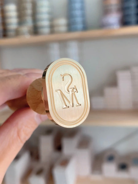 Oval custom wax seal stamp head with personalized monogram letters and double line border design