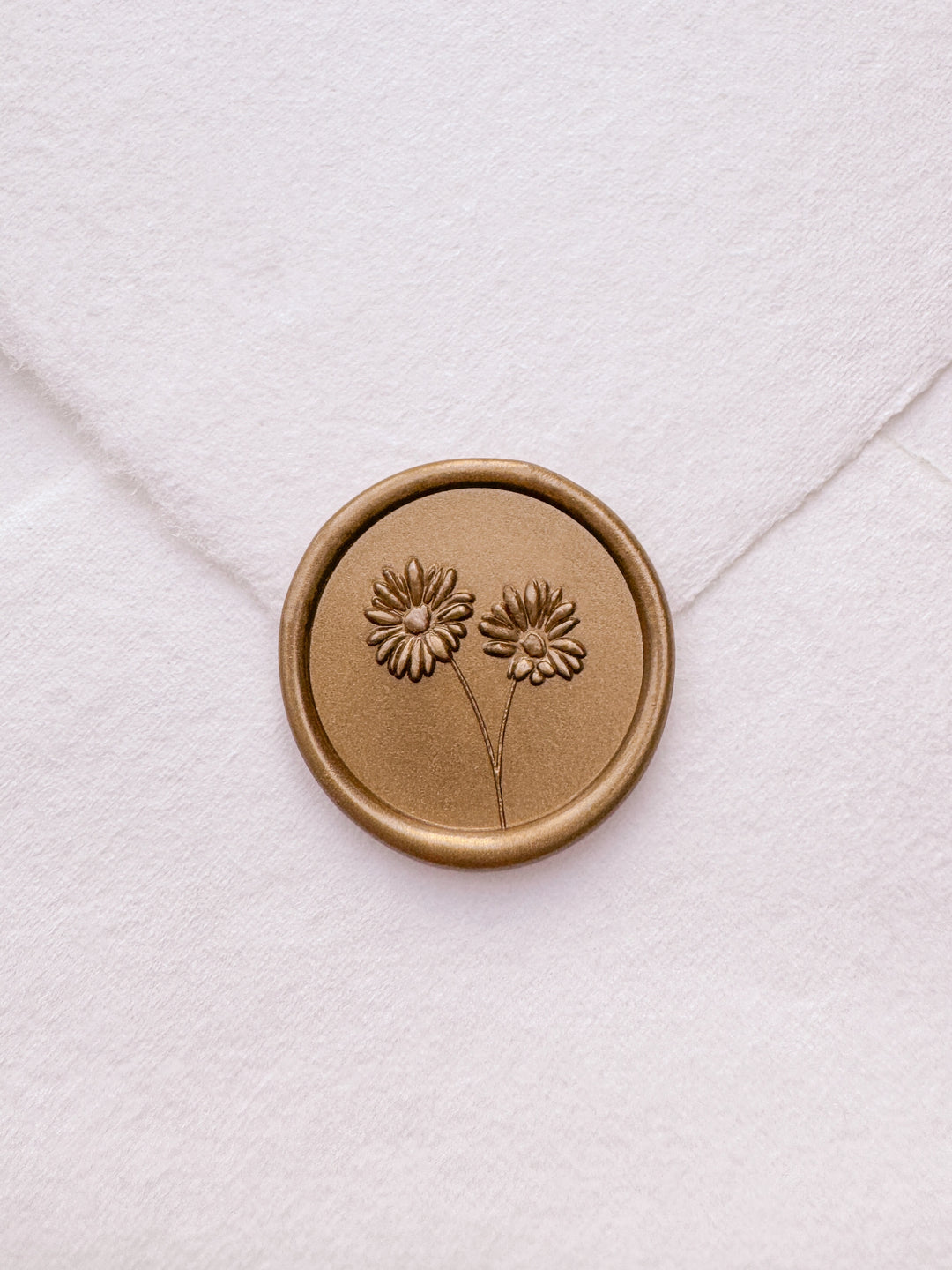 gold daisies flower bouquet wax seal on a white envelope