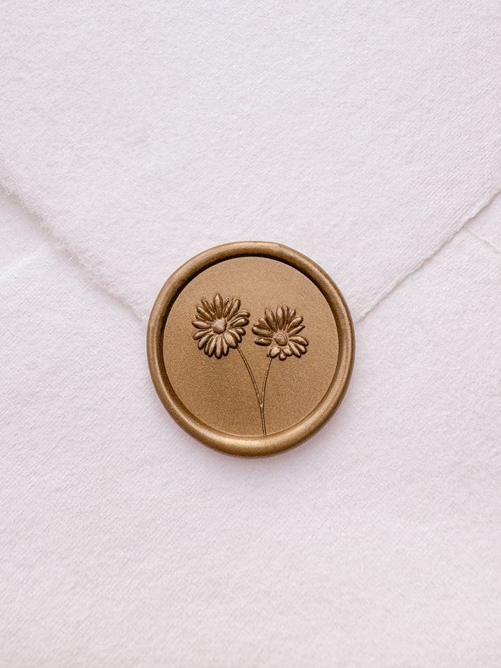 gold daisies flower bouquet wax seal on a white envelope