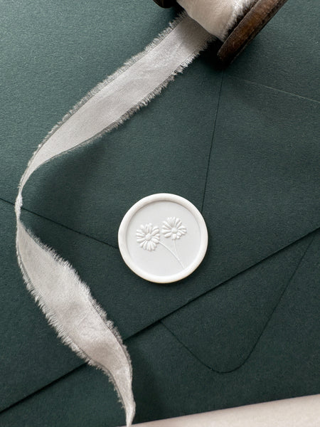 Daisies white wax seal on dark green envelope styled with white silk ribbon 