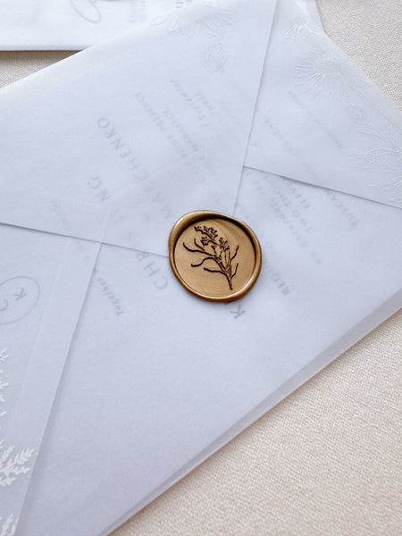 Gold eucalyptus leaf wax seal on vellum wedding invitation envelope