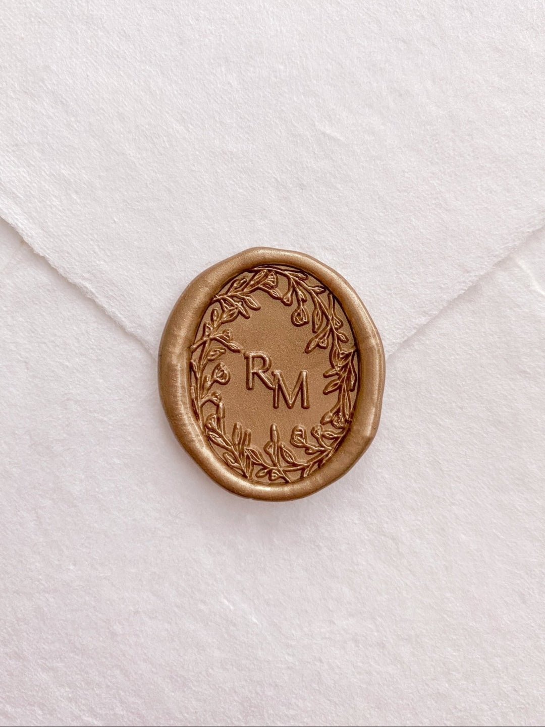 Oval floral crown monogram gold custom wax seal on beige handmade paper envelope 