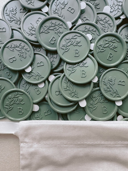 Sage green floral monogram wax seal stickers with adhesive backings