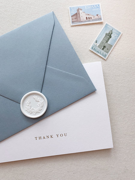 Gold foil press white thank you card with dusty blue envelope and wreath design white wax seal