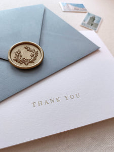 Gold foil press white thank you card with dusty blue envelope and wreath design gold wax seal