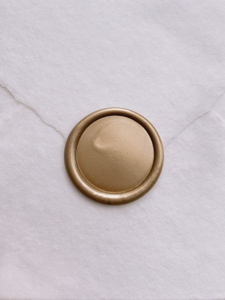 Light matte gold blank wax seal on white handmade paper envelope