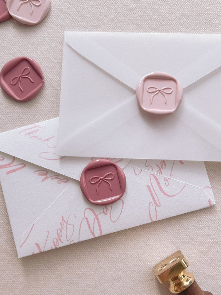 dusty pink and rose pink 3D ribbon bow mini square wax seals on mini vellum and pink envelopes 
