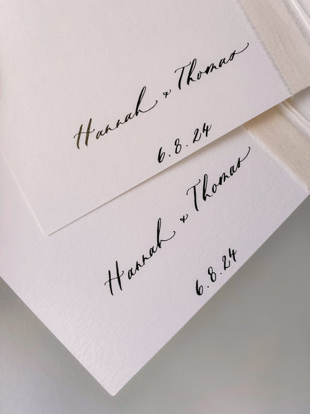 Personalized names and wedding date in calligraphy on the inner cover of a set of ivory vow books 
