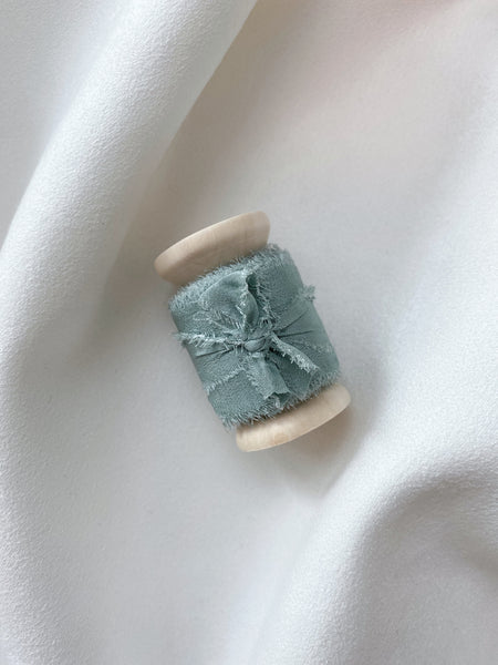 1 inch eucalyptus silk ribbon on a wooden spool