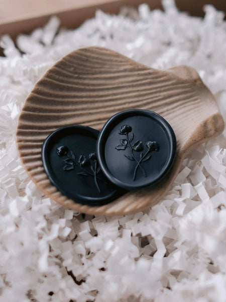 3D floral design oval black wax seals on a ceramic ring dish