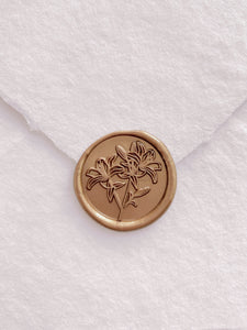 Lily floral round wax seal in gold on handmade paper envelope
