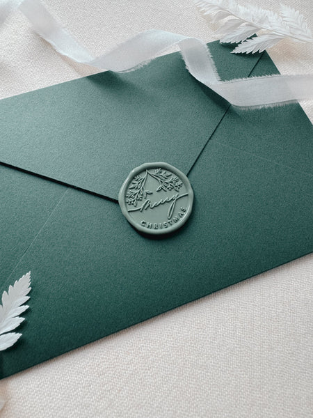 green Merry Christmas wax seal on green envelope