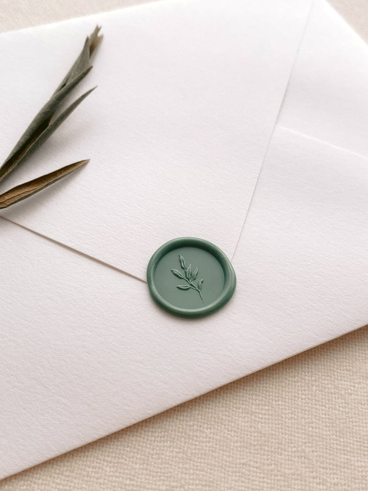 Green 3D leaf mini wax seal on a white envelope