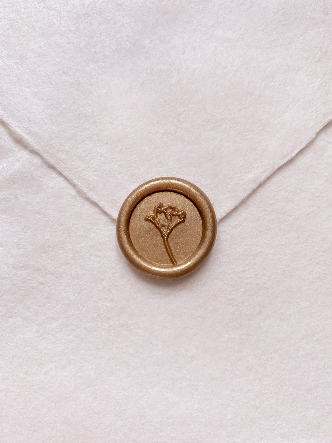 Gold mini flower wax seal on beige handmade paper envelope