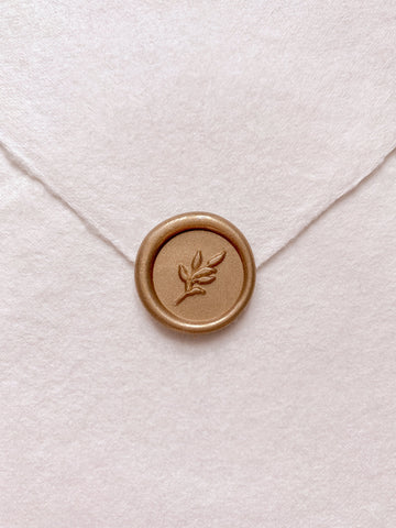 Gold mini leaf wax seal on beige handmade paper envelope