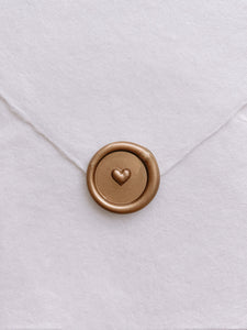 Gold mini 3D engraved heart wax seal on white handmade paper envelope