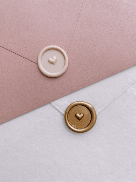 Nude and gold mini 3D engraved heart wax seals on pink and white envelopes