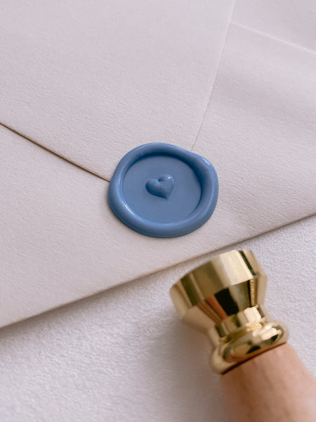 Dusty blue mini 3D engraved heart wax seal on beige envelope styled with wax seal stamp with wooden handle