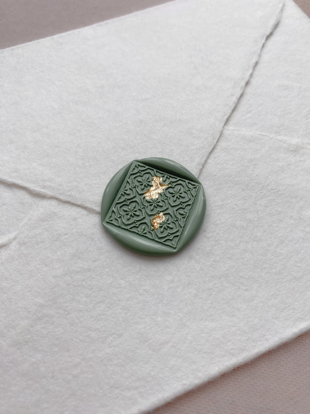 Moroccan tile pattern diamond shaped wax seal in sage green on handmade paper envelope