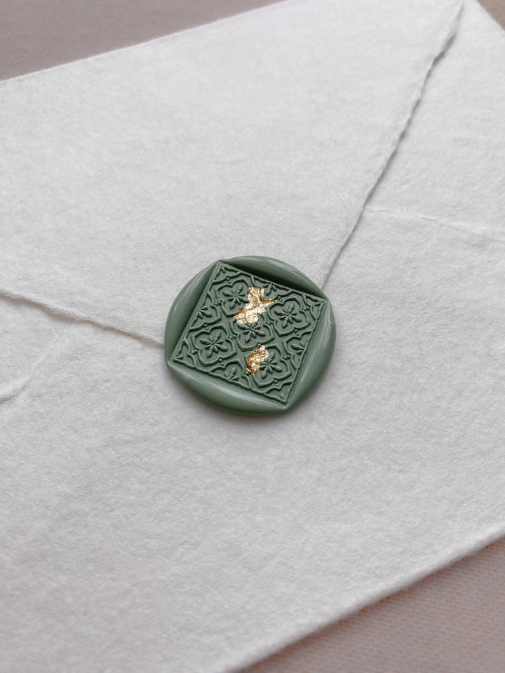 Moroccan tile pattern diamond shaped wax seal in sage green on handmade paper envelope