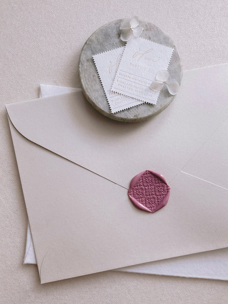 Moroccan tile pattern wax seal in dusty rose on beige envelope 