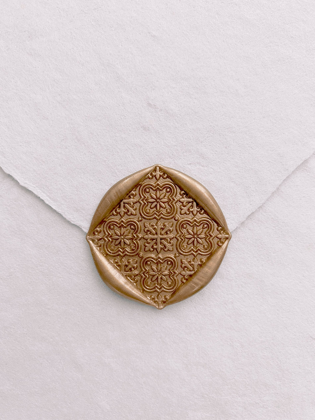 Moroccan tile pattern square shaped wax seals in gold on handmade paper white envelope_front angle