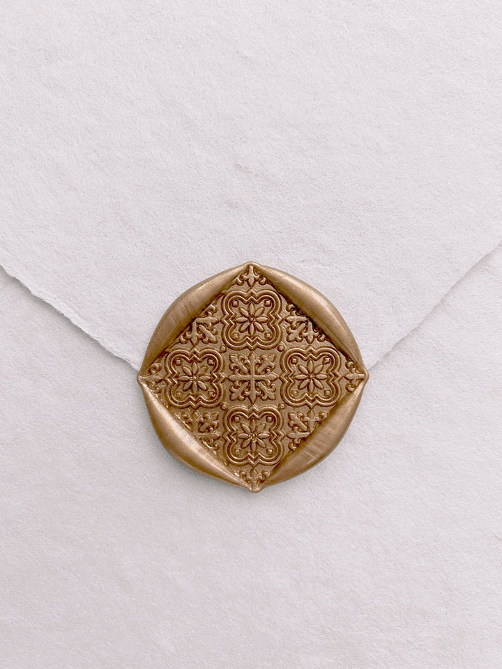 Moroccan tile pattern square shaped wax seals in gold on handmade paper white envelope_front angle