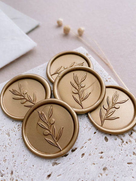 Olive branch wax seals in gold close up