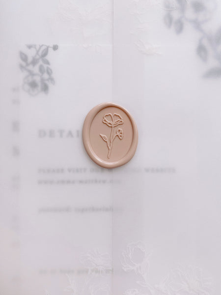 Oval floral wax seal in nude on a vellum jacket with wedding invitation